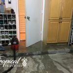 Water pouring out of door into garage